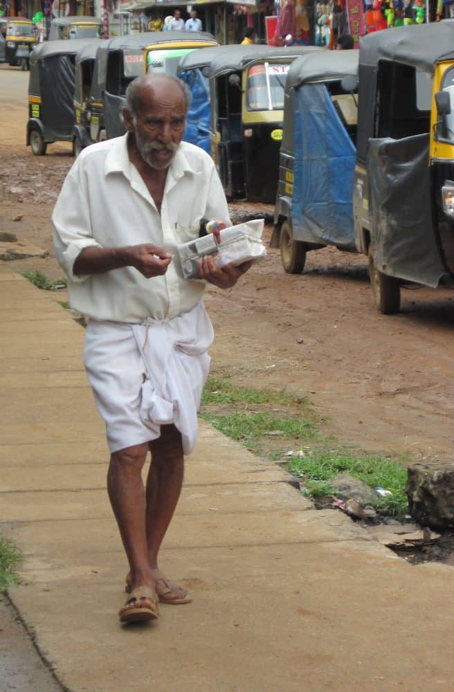 Standard garb for men is the dhoti, worn longor short. Photo by Christine Tibbetts