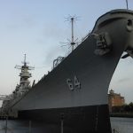 USS Wisconsin towers over Norfolk's waterfront.