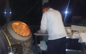 Baker at Sufra Restaurant making bread in his Taboon
