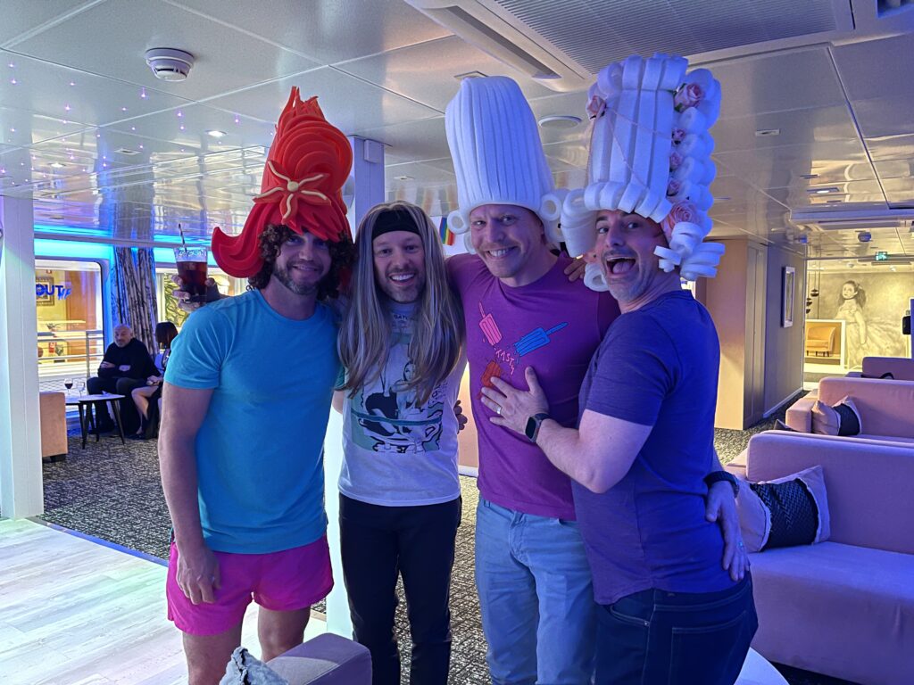 4 men wearing wigs while smiling