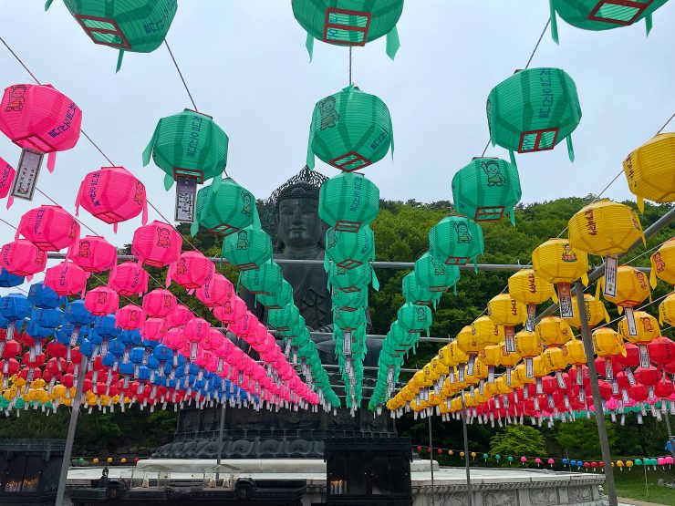 In front of the statue is a square filled with colorful lanterns where visitors can write their wishes, prayers, and hopes on paper, offering them to Buddha.