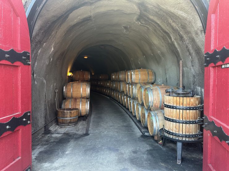 Toogood winery's cellar with wine barrels and vintage wine press