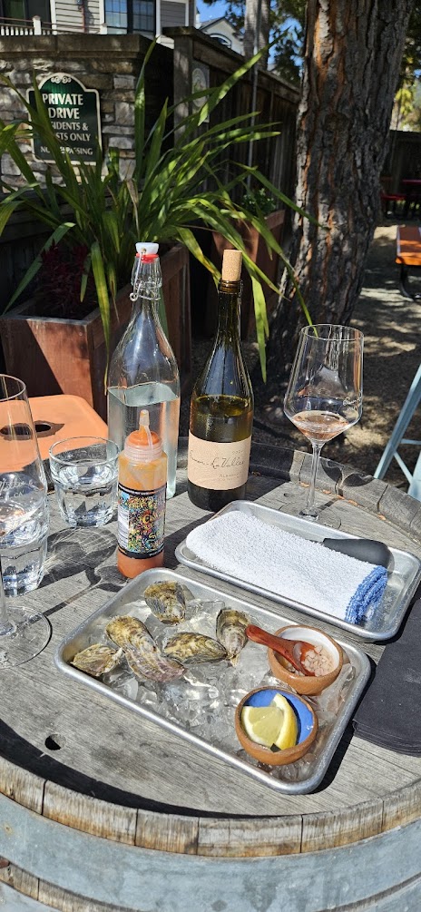 shucking oysters and tasting wine beachside