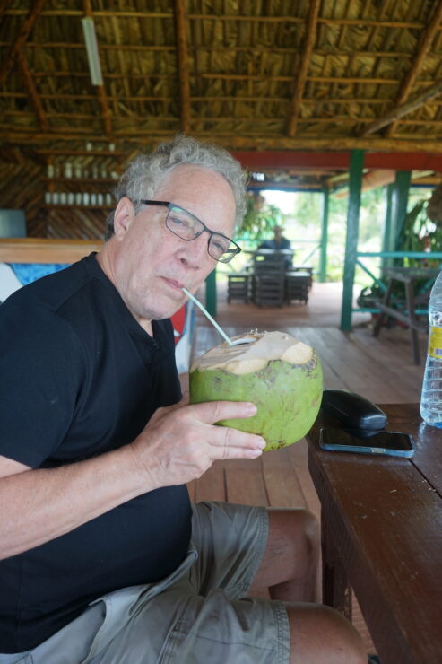 Author enjoying a fresh coconut drink in Cuba.