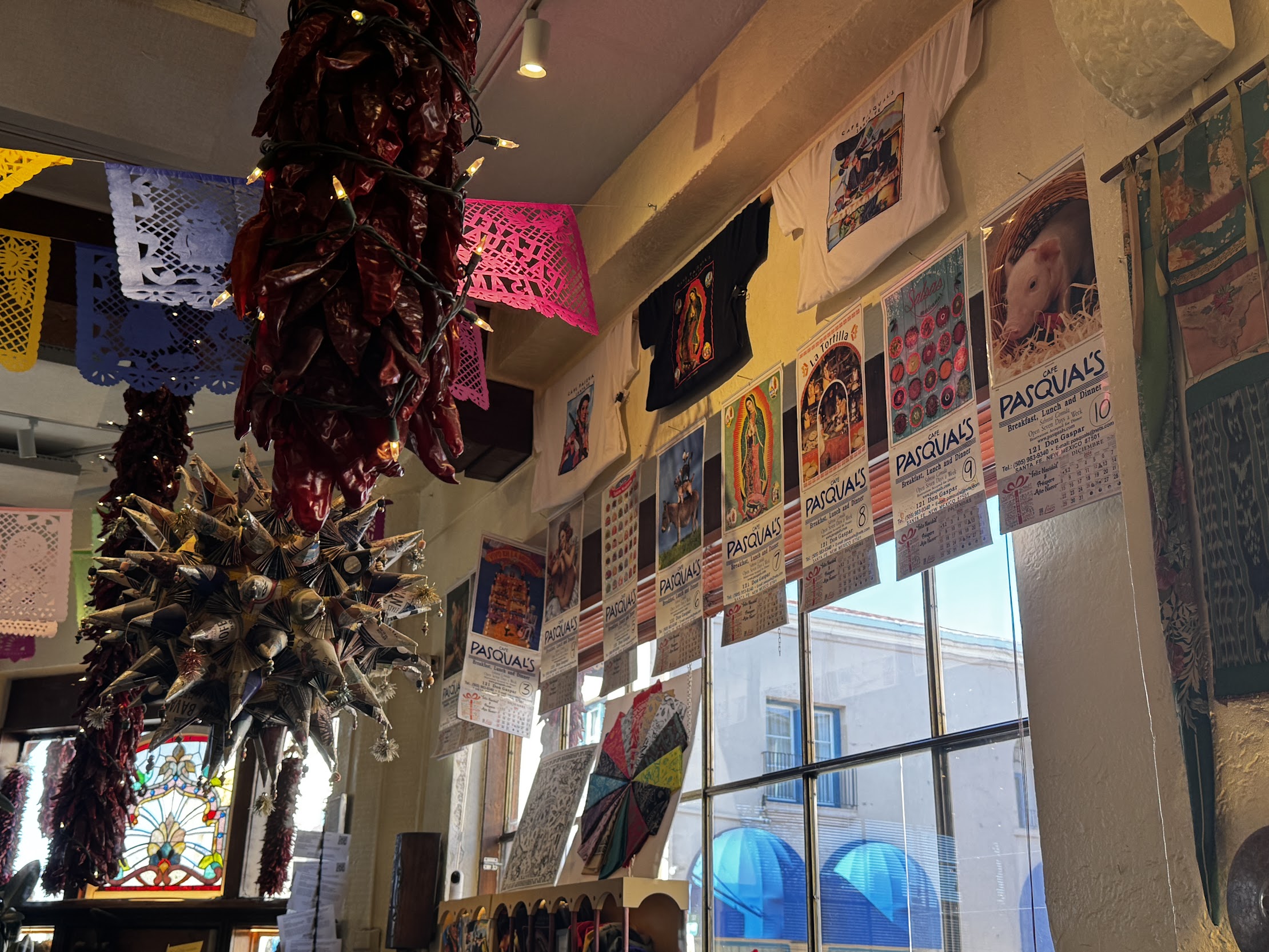 Interior of cafe with calendars hanging above windows and warm lighting