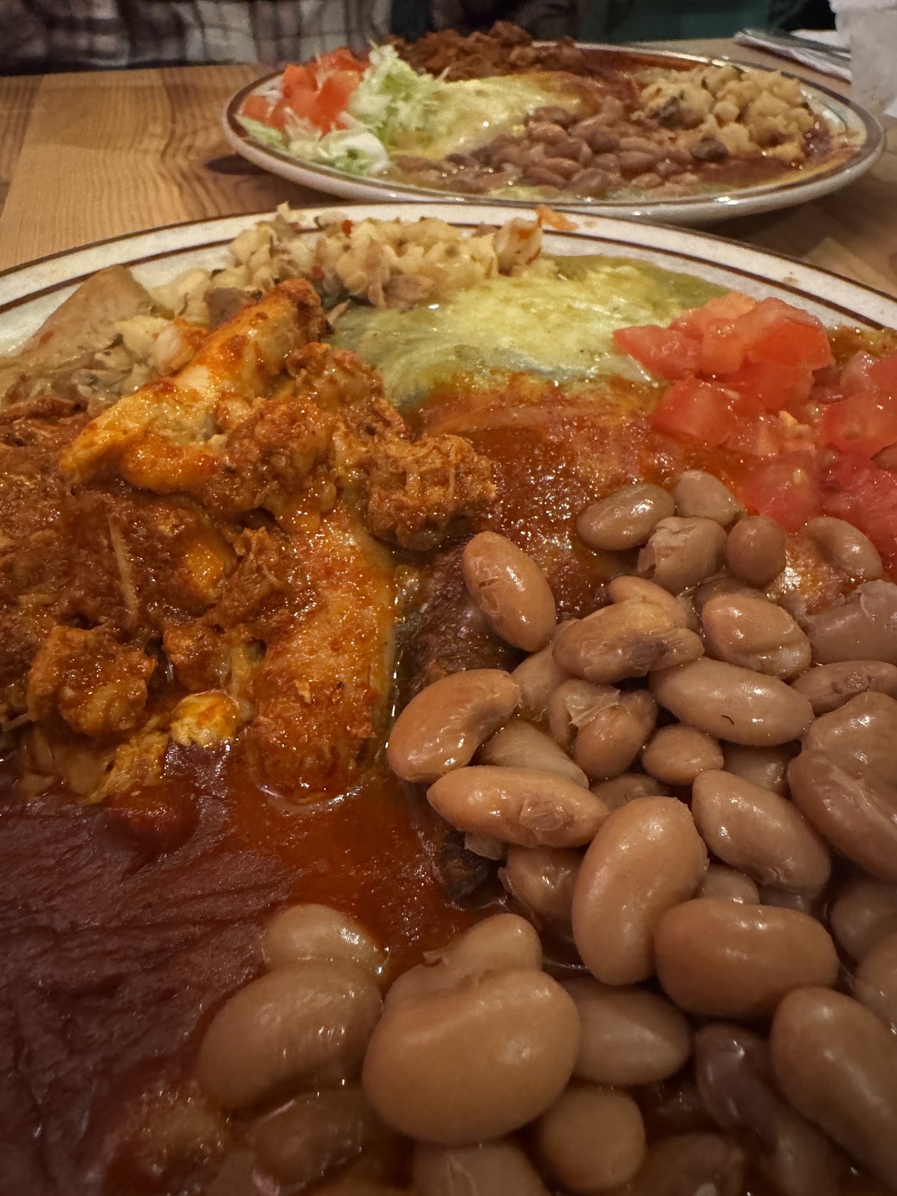 Plate of beans, ground beef and red and green Chile