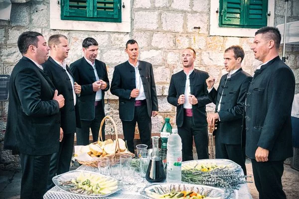 Klapa Singers around a table full of food on the Island of Hvar.