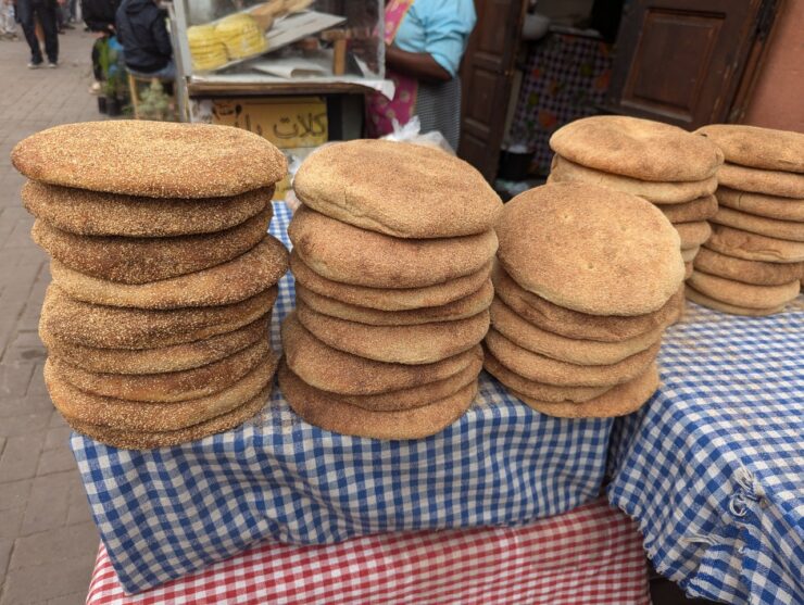 Stacks of flat bread on a table in the market.