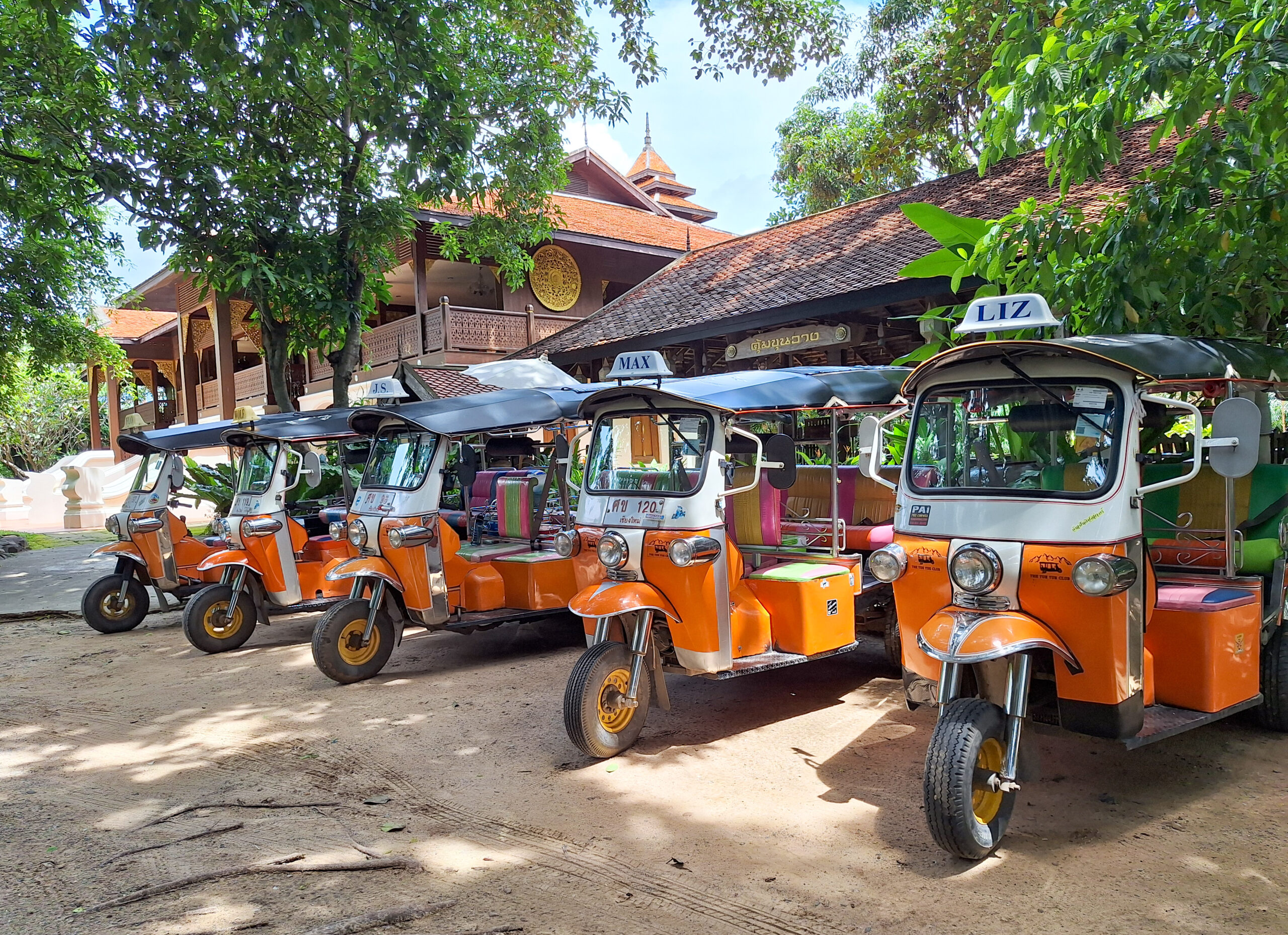Orange Tuk Tuks lined up in a row