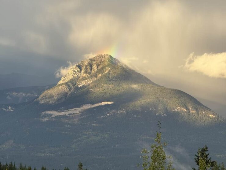 Rainbow over snowcapped mountains