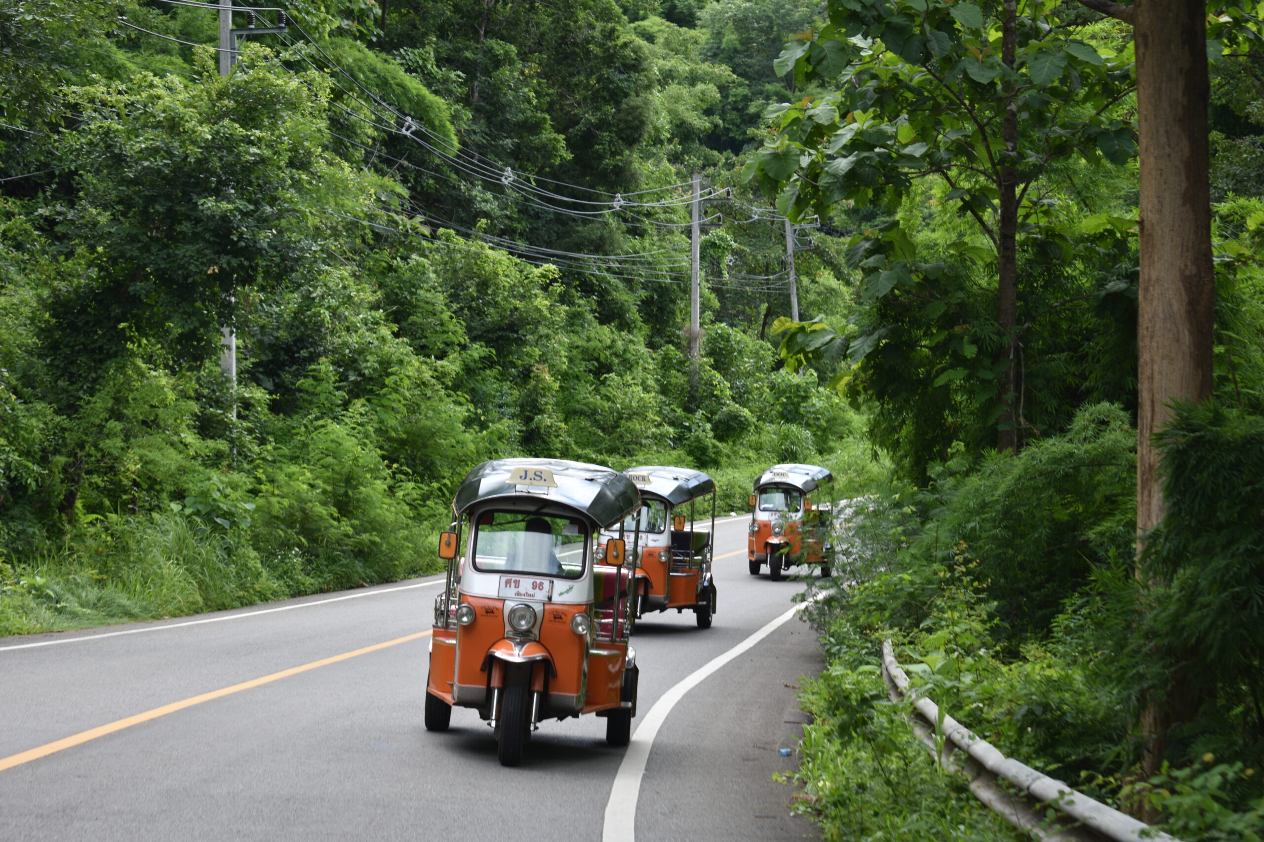 Tuk Tuks on the road in convoy