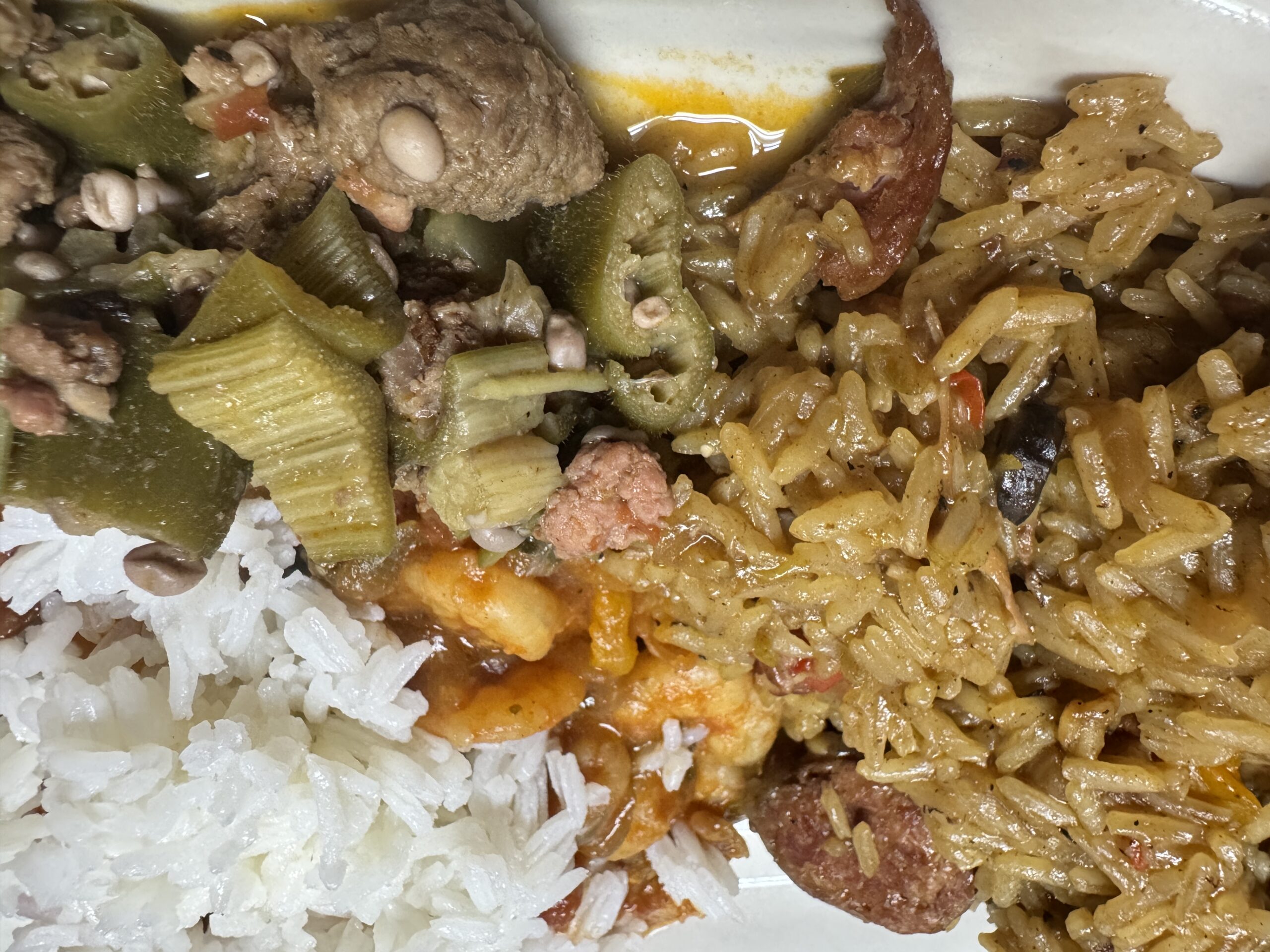 A Cajun Feast in the making, showing ingredients of rice, celery, sausage, and shrimp.