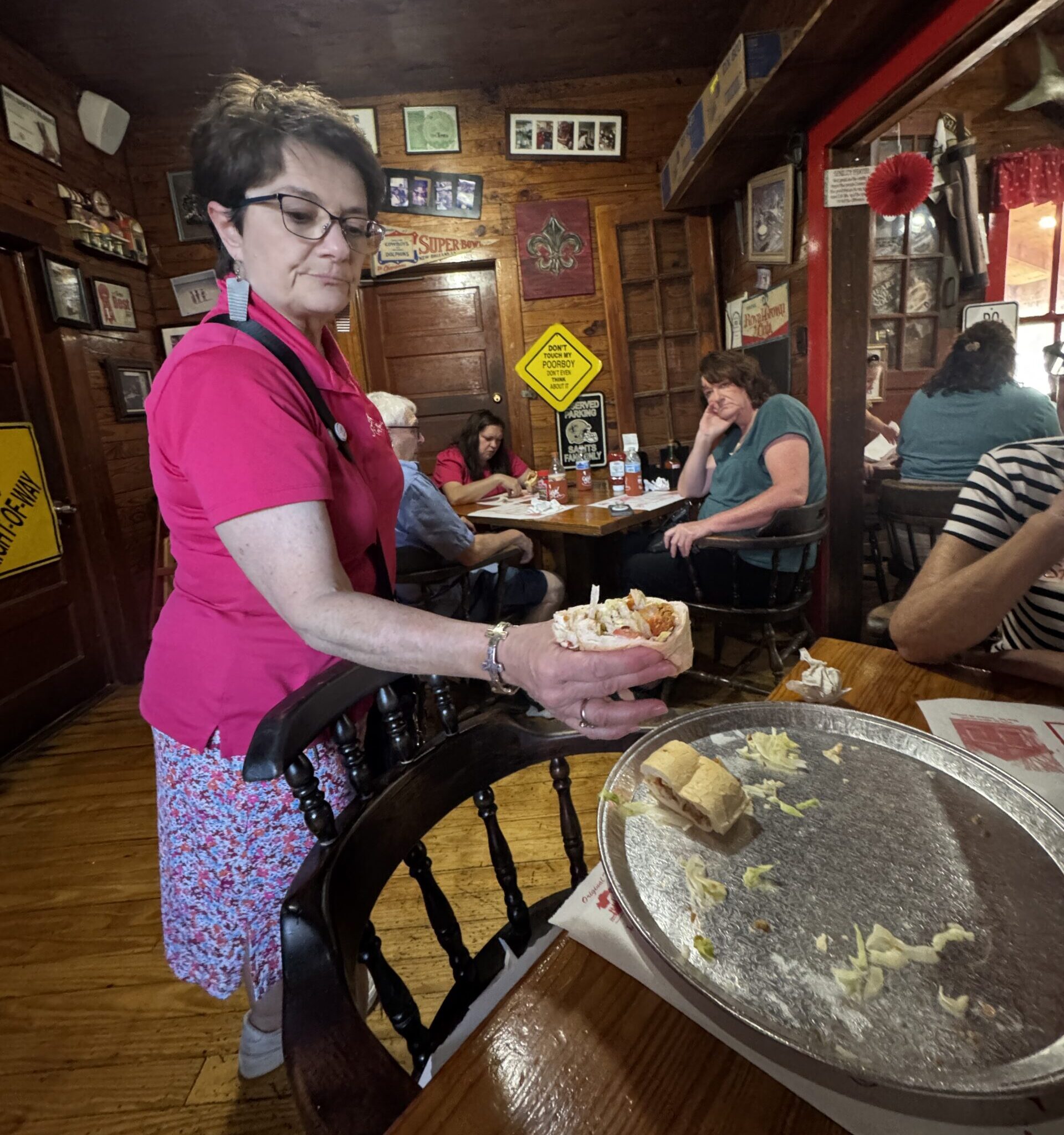 Marie Ducote-Comeaux from Cajun Food Tours holding a Po'Boy Sandwich.