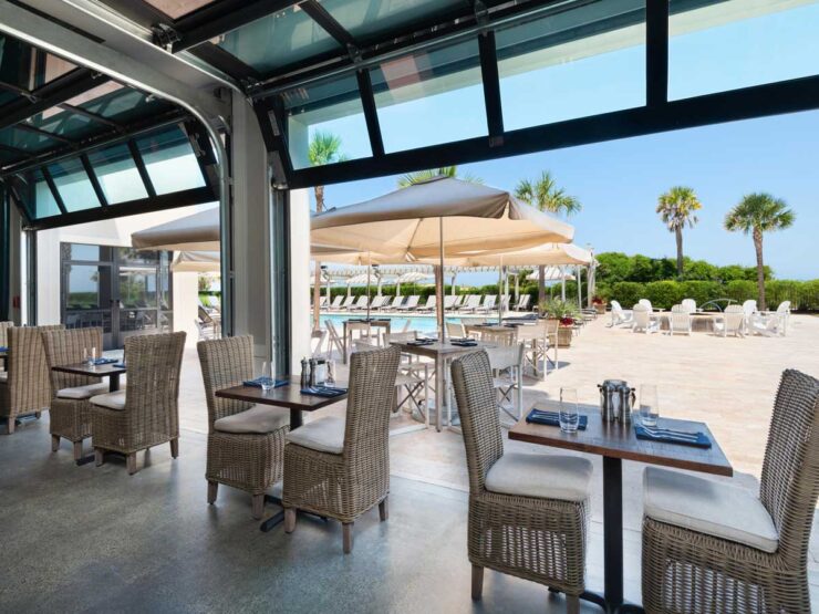 Eighty Ocean Kitchen and Bar tables with view to the pool