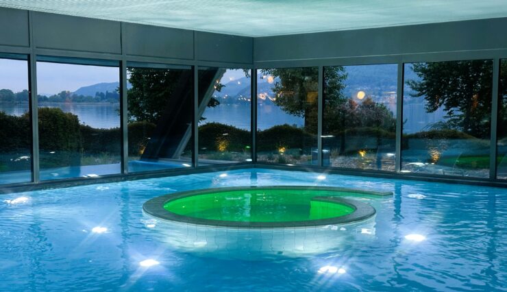 Glass-enclosed pool and spa at Deltapark Vitalresort. @Barbara Redding