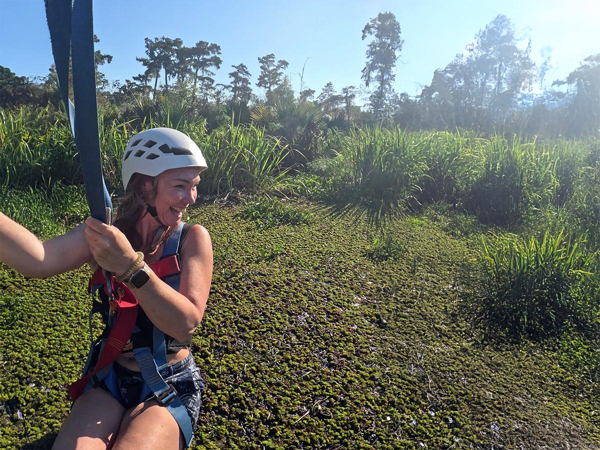 Woman ziplining over a swamp in Louisiana.