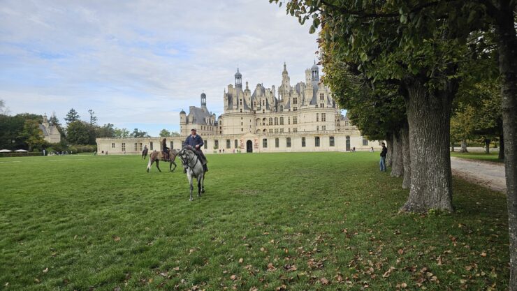 Horses using one of the front lawns at Chateau de Chambord warming up for the equestrian show 