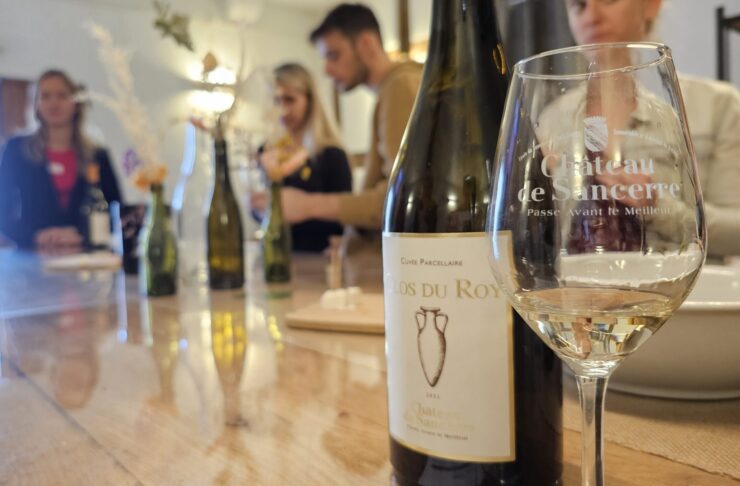 Wine glass and bottle at the counter of a wine tasting at Chateau Sancerre