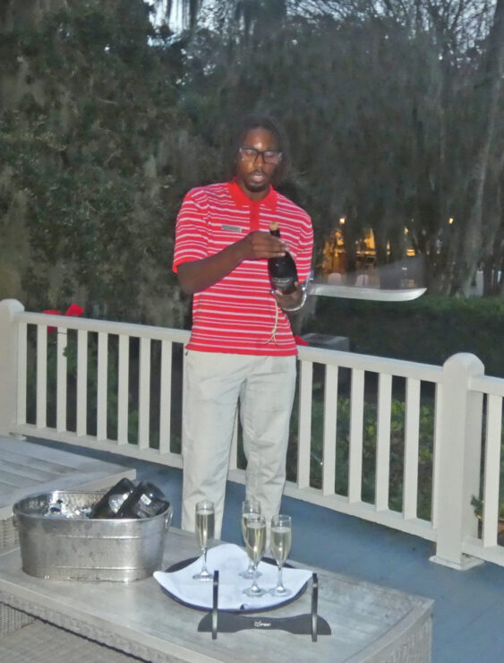 Staff member preparing for a champagne sabering.