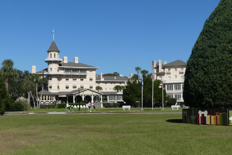 Resort with a turret and green lawn in front.