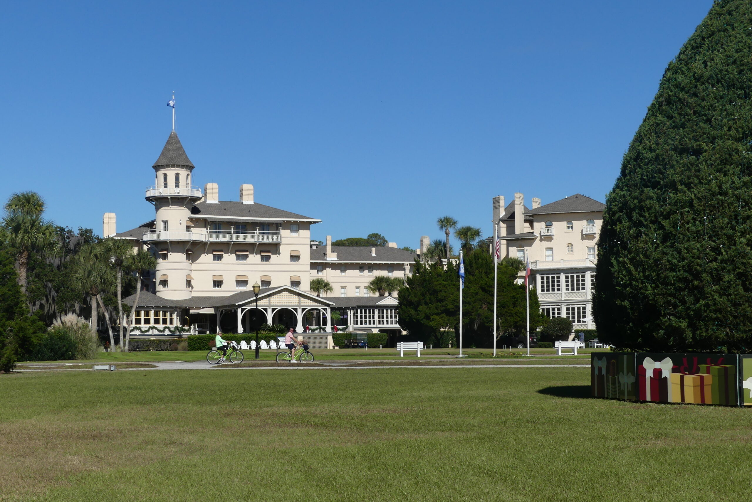 Resort with a turret and green lawn in front.