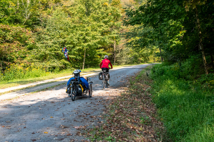 Two bike riders traversing the dirt trail in a forest setting of the Pennsylvania Grand Canyon.
