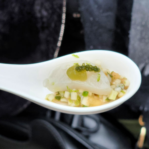 amuse bouche spoon filled with green and white bits at Habits de Saveurs culinary demo