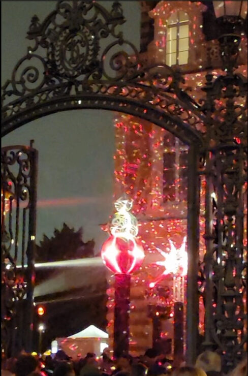 wrought iron gate and Victorian mansion decorated in lights for the Habits de Lumière Epernay