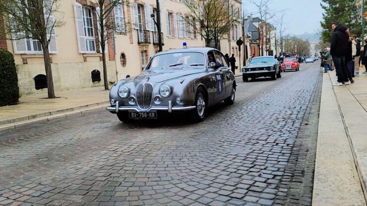 Vintage Jaguar rolls during Habits de Lumière Epernay car parade followed by a 64 Mustang and Vintage red citronen 