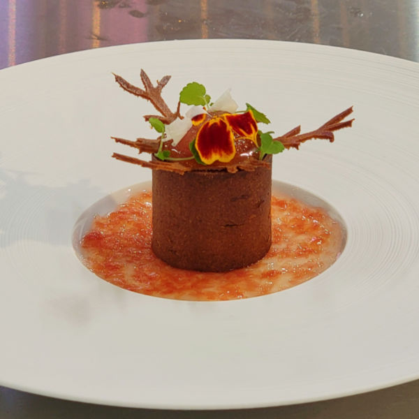 eye catching Habits de Saveurs appetizer with flowers and twigs decorating the top