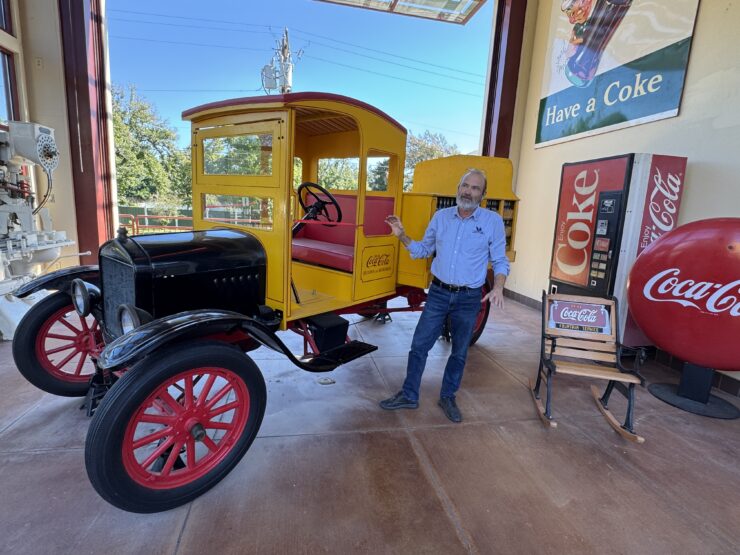 Ralph Calhoun, executive director of the Biedenharn Museums and Gardens, is pictured outside the entrance, near the vintage Model T Coca-Cola delivery truck.