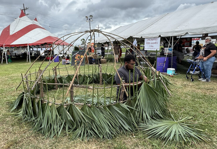 A palmetto hut being constructed as part of the Folklife Village at the Rougarou Fest.