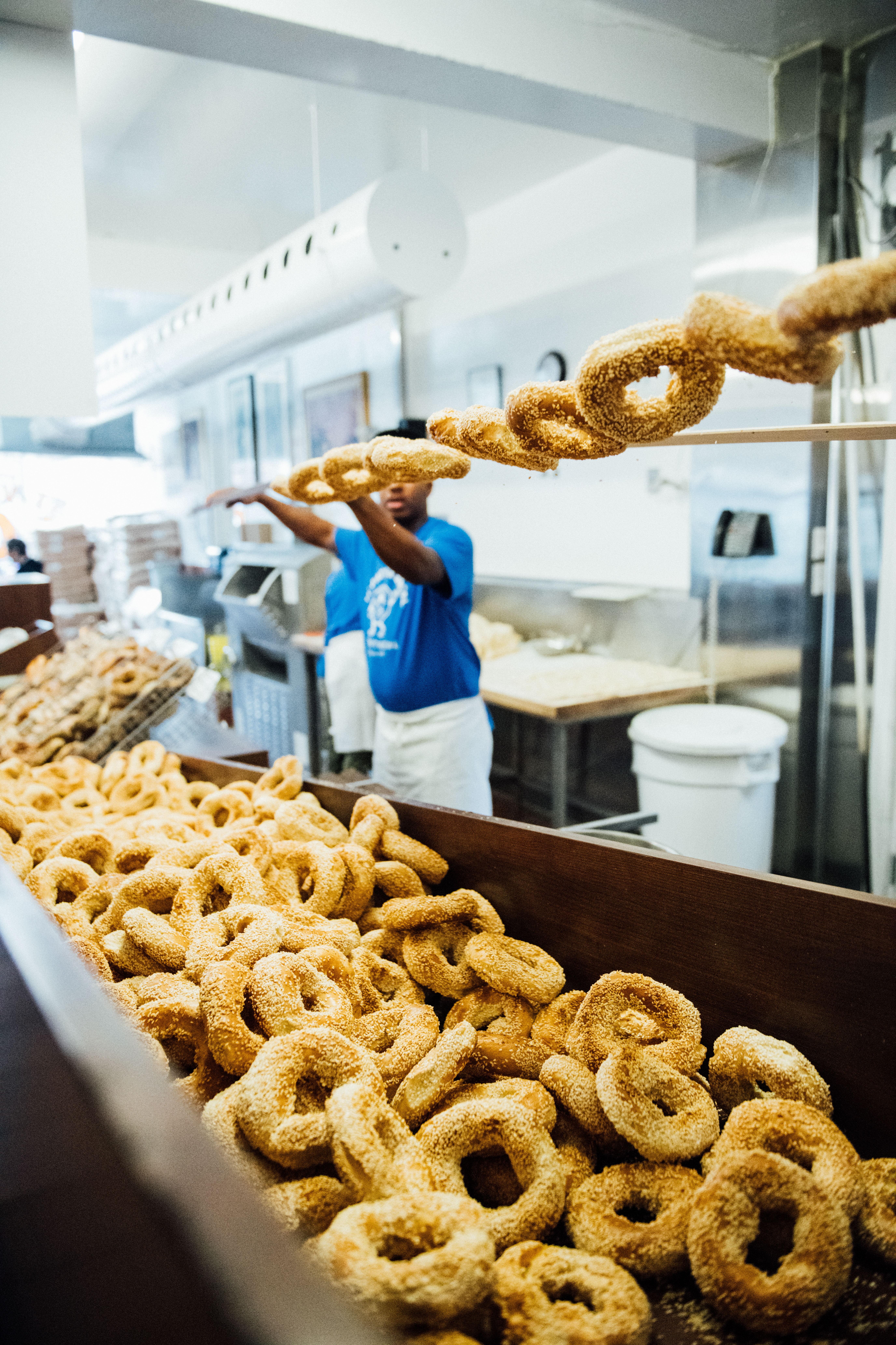 A baker tosses a freah batch from the wood-burning oven at St-Viateur Bagel in Montreal. ©Alison Slattery Tourisme Montreal
