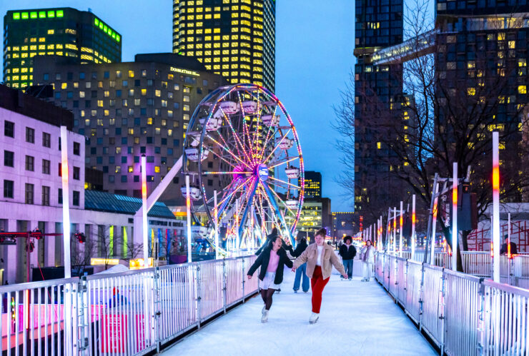 Two people people skate on the the 300-metre elevated, LED-lit skating trail that’s created every year for Montréal en Lumière.©Eva Blue Tourisme Montreal