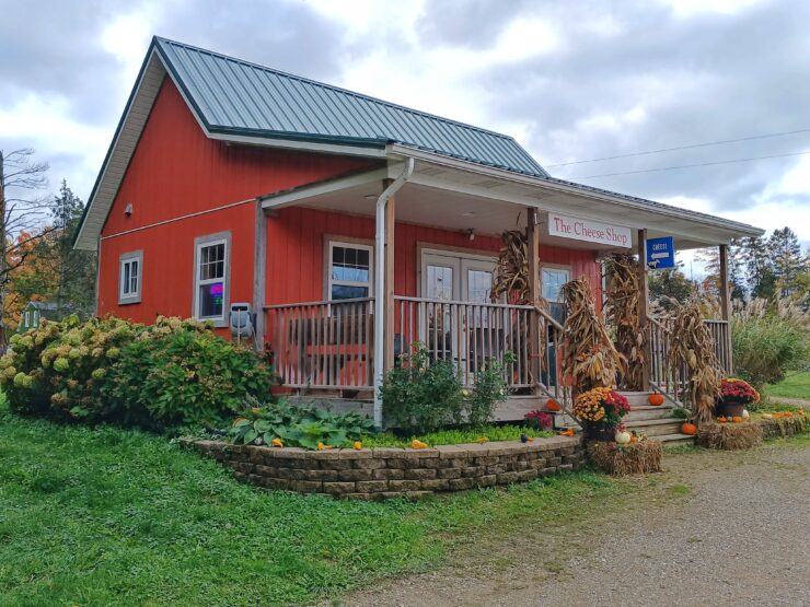 Small red building with porch and sign reading The Cheese Shop