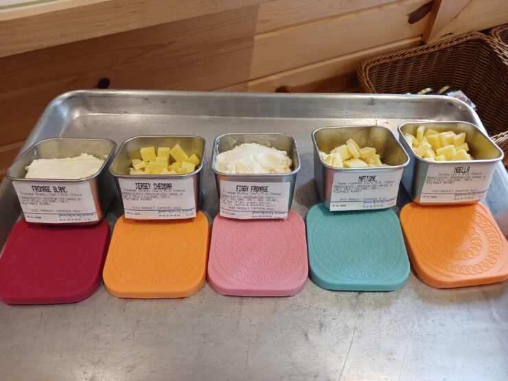 Selection of cow milk cheeses in small metal bowls