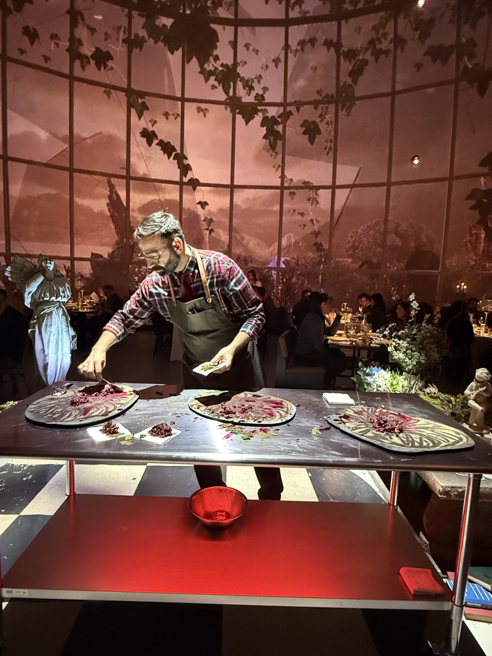 A chef prepares a course during a dinner inside a dome in Montreal.