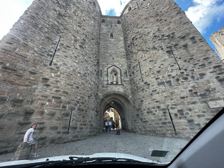 a small arched gate in the massive stone walls