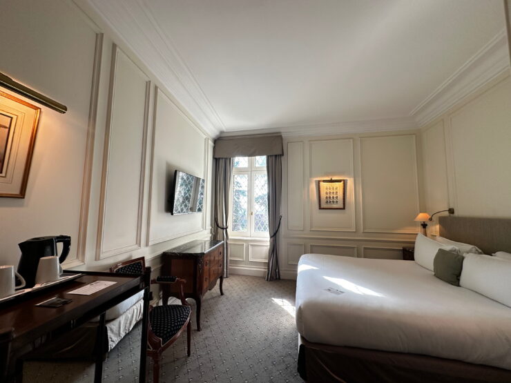 hotel room with bed and desk, mullioned windows