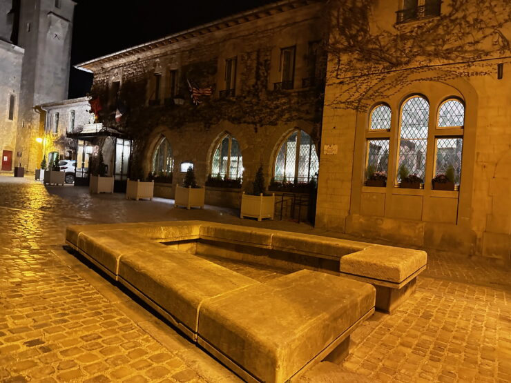 Empty medieval street in yellow light outside Hotel de la CIte Carcassonne