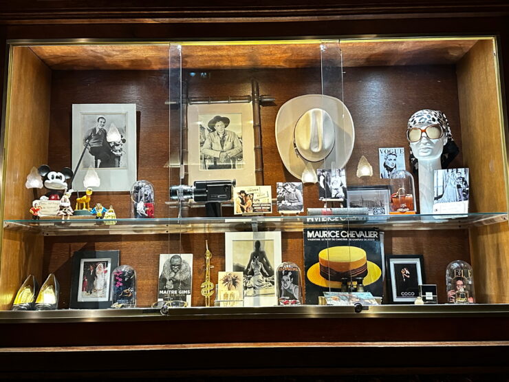 photos, hat, shoes, album cover and other mementos in a glass case