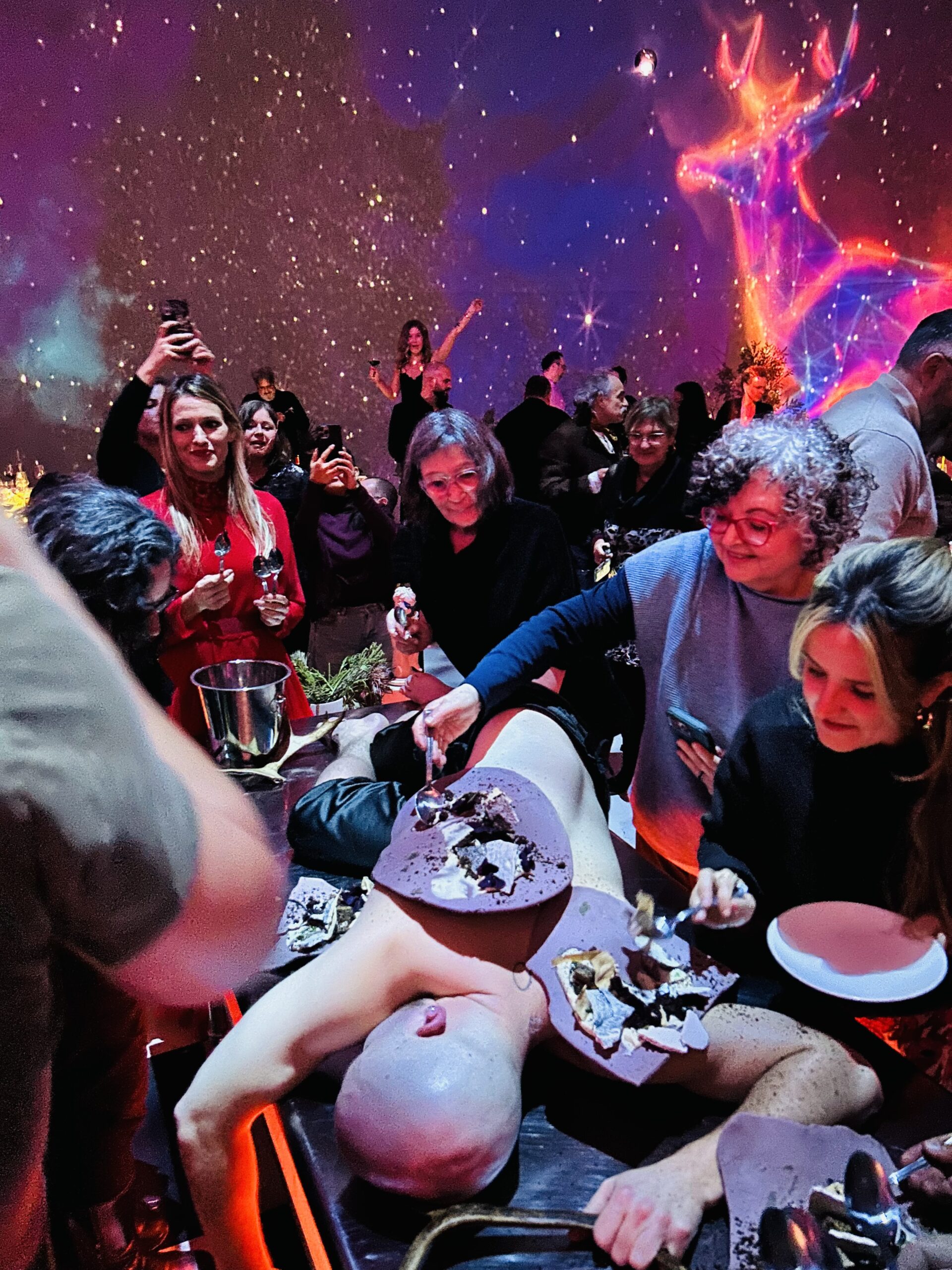 Writer Linda Barnard, second from top left, digs in as a performer becomes a serving dish for dessert at “La Vie, le mort, le dessert” in Montreal