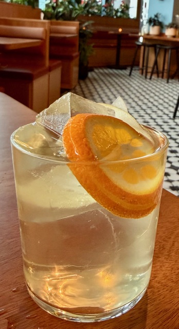 A white wine sangria flavored with lychee, transparent ice cubes.