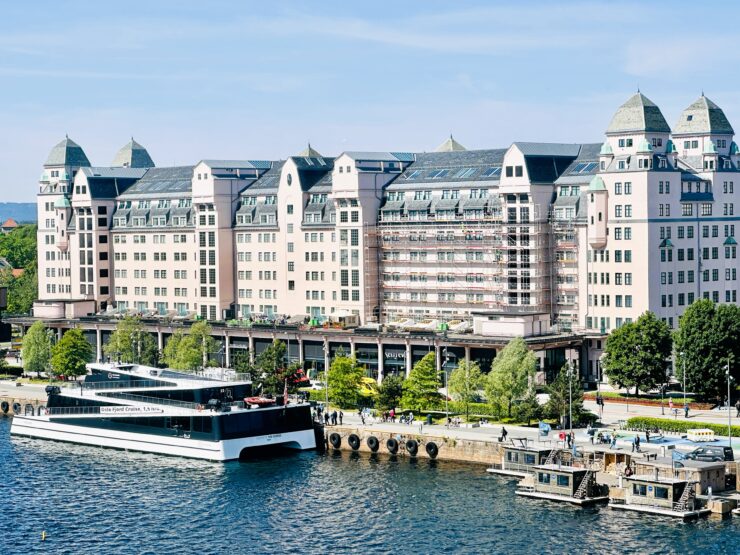 Vision of the Fjords tour boat docked near several saunas. 