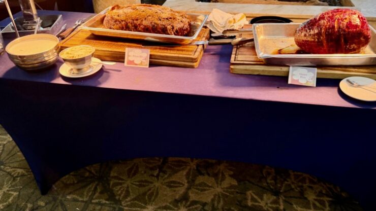 Carving table with roasted meats and serving platters at Sunday brunch at Mission Resort + Club in Howey-in-the-Hills, Florida.