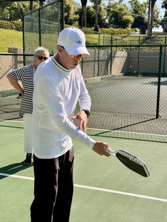 Cesar Villarroel demonstrating proper pickleball racquet handling on an outdoor court at Mission Resort + Club in Howey-in-the-Hills, Florida.