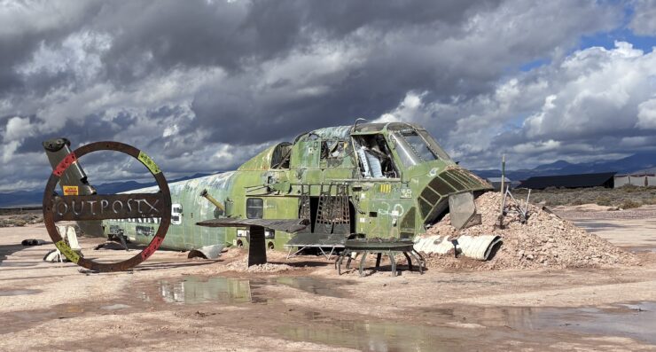 The remains of a derelict helicopter welcome guests to Outpost X. ©Julia Bayly