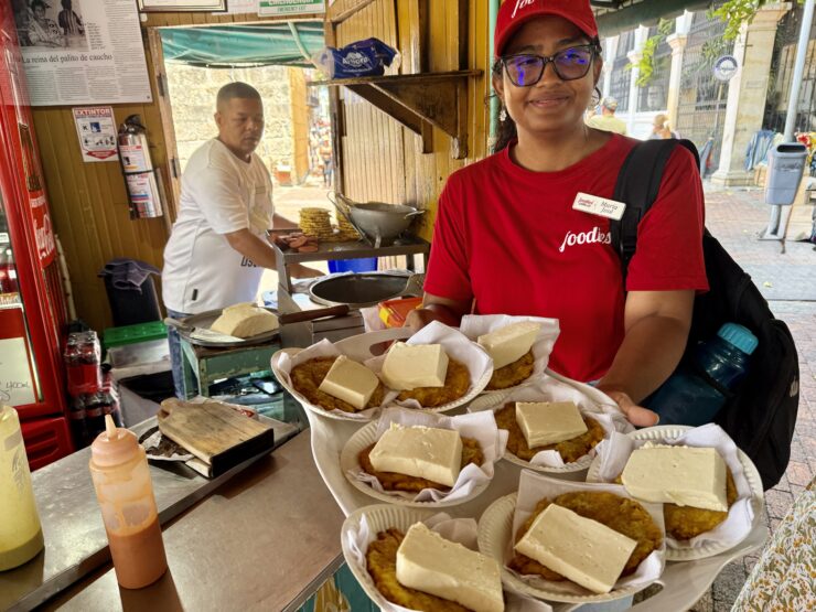 A tour guide with patacones, made with fried green plantains.