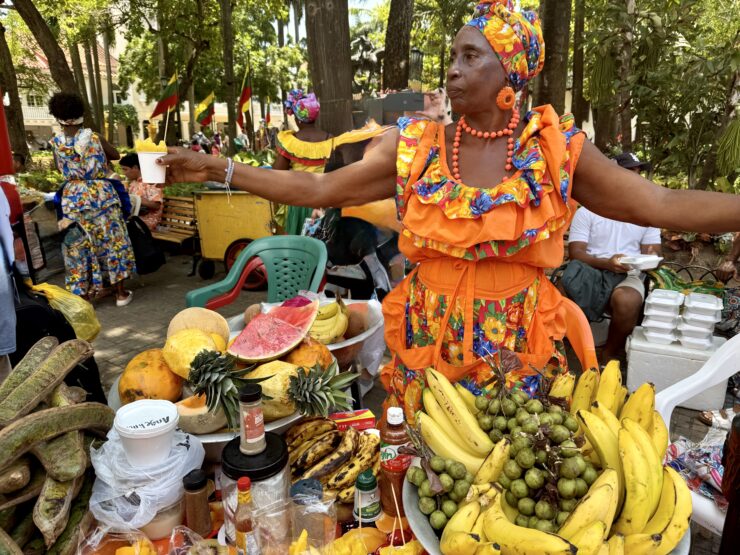 A fruit seller passes out fresh pineapple in Cartagena.