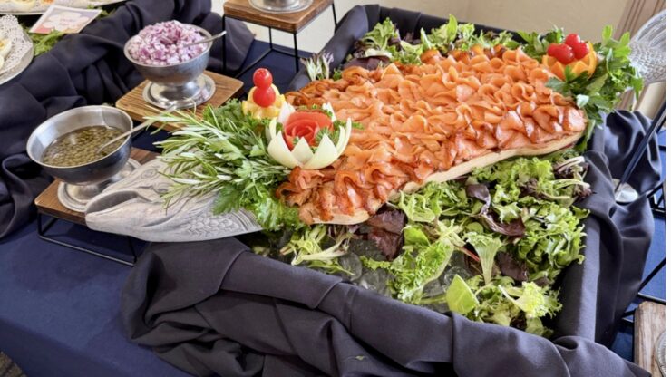 Salmon platter with fresh greens, tomatoes, olives, and garnish at Mission Resort + Club in Howey-in-the-Hills, Florida.